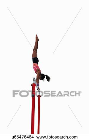 Young gymnast performing on uneven bars View Large Photo Image Picture - Young gymnast performing on uneven bars. Fotosearch