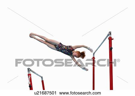 Young gymnast performing on uneven bars View Large Photo Image Stock Image - Young gymnast performing on uneven bars. Fotosearch