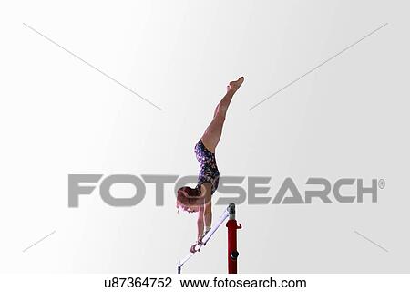 Young gymnast performing on uneven bars View Large Photo Image Stock Image - Young gymnast performing on uneven bars. Fotosearch