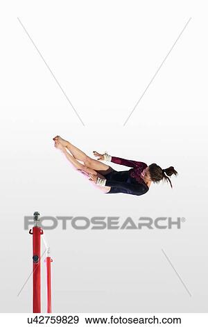 Young gymnast performing on uneven bars View Large Photo Image Stock Photo - Young gymnast performing on uneven bars. Fotosearch
