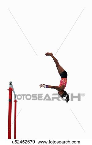 Stock Photo - Young gymnast performing on uneven bars. Fotosearch