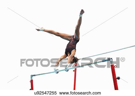 Young gymnast performing on uneven bars View Large Photo Image Stock Photography - Young gymnast performing on uneven bars. Fotosearch