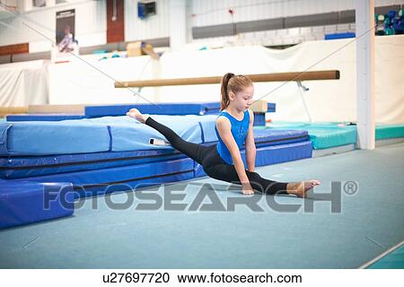 Young gymnast practising moves View Large Photo Image Stock Image - Young gymnast practising moves. Fotosearch