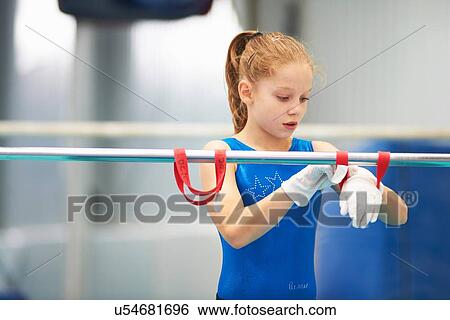 Young gymnast using training wrist straps to aid practise on bars View Large Photo Image Stock Photograph - Young gymnast using training wrist straps to aid practise on bars. Fotosearch