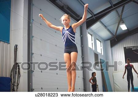 Stock Image - Young gymnasts practising moves. Fotosearch