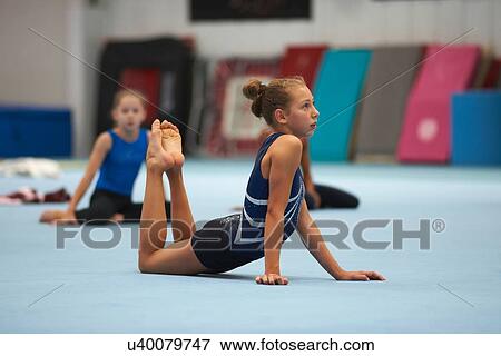 Stock Photo - Young gymnasts practising moves. Fotosearch