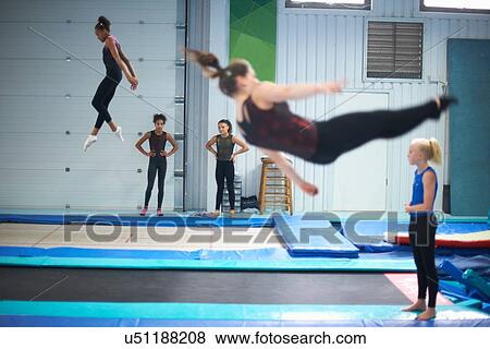 Stock Photo - Young gymnasts practising moves. Fotosearch