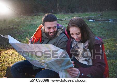 Young hiking couple reading map in woods View Large Photo Image Stock Photo - Young hiking couple reading map in woods. Fotosearch