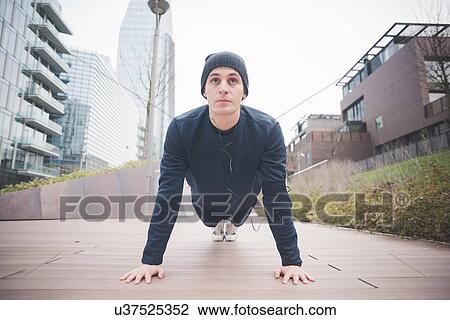 Young male runner doing push ups in city View Large Photo Image Stock Image - Young male runner doing push ups in city. Fotosearch