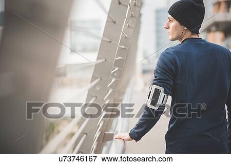 Young male runner on city footbridge View Large Photo Image Stock Photo - Young male runner on city footbridge. Fotosearch