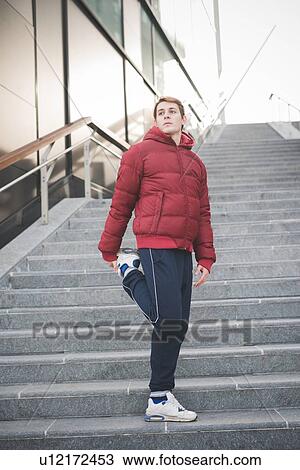 Young male runner on city stairs warming up View Large Photo Image Stock Image - Young male runner on city stairs warming up. Fotosearch