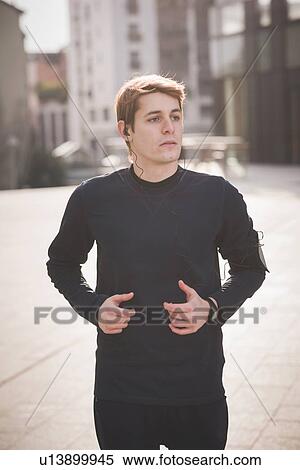 Young male runner running through city square View Large Photo Image Stock Photography - Young male runner running through city square. Fotosearch