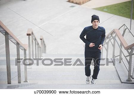 Young male runner running up city stairs View Large Photo Image Stock Image - Young male runner running up city stairs. Fotosearch