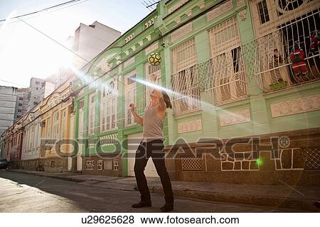 "Young man celebrating with football skills in the street, Rio de Janeiro, Brazil" View Large Photo Image Stock Photo - "Young man celebrating with football skills in the street, Rio de Janeiro, Brazil". Fotosearch