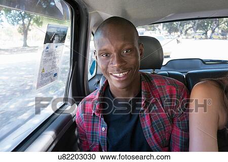 "Young man in car smiling, portrait" View Large Photo Image Stock Image - "Young man in car smiling, portrait". Fotosearch