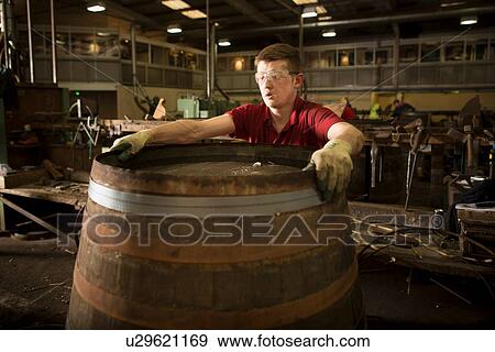 Young man making whisky cask at cooperage View Large Photo Image Stock Photo - Young man making whisky cask at cooperage. Fotosearch