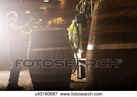 Young man making whisky cask in cooperage View Large Photo Image Stock Photo - Young man making whisky cask in cooperage. Fotosearch