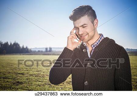Young man on cell phone View Large Photo Image Stock Image - Young man on cell phone. Fotosearch