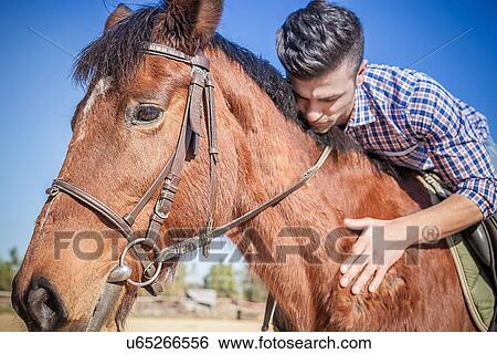 Young man on horse View Large Photo Image Stock Photograph - Young man on horse. Fotosearch
