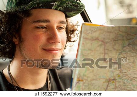 "Young man reading map in back seat of taxicab, Rio De Janeiro, Brazil" View Large Photo Image Stock Photo - "Young man reading map in back seat of taxicab, Rio De Janeiro, Brazil". Fotosearch