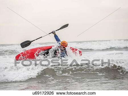 Stock Photograph - Young man sea kayaking. Fotosearch