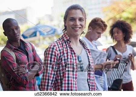 Young man smiling towards camera View Large Photo Image Stock Image - Young man smiling towards camera. Fotosearch