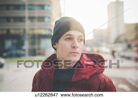 Young man staring from city street View Large Photo Image Stock Photo - Young man staring from city street. Fotosearch