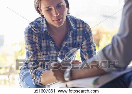 Stock Image - Young man studying. Fotosearch