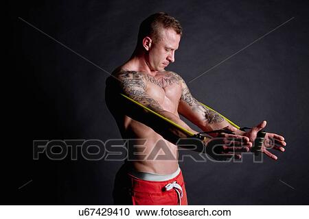 Young man using resistance band View Large Photo Image Stock Image - Young man using resistance band. Fotosearch