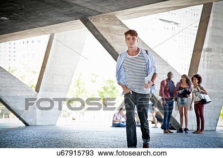 Young man walking towards camera View Large Photo Image Stock Image - Young man walking towards camera. Fotosearch