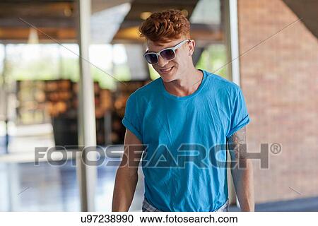 "Young man wearing blue t shirt, portrait" View Large Photo Image Stock Image - "Young man wearing blue t shirt, portrait". Fotosearch