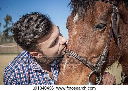 Stock Photograph - Young man with horse. Fotosearch