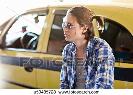 Young man with ponytail View Large Photo Image Stock Photo - Young man with ponytail. Fotosearch