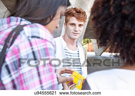 Stock Image - Young man with red hair looking at camera. Fotosearch