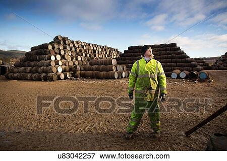 Stock Photo - Young man working at cooperage. Fotosearch