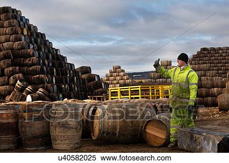 Stock Photography - Young man working at cooperage. Fotosearch