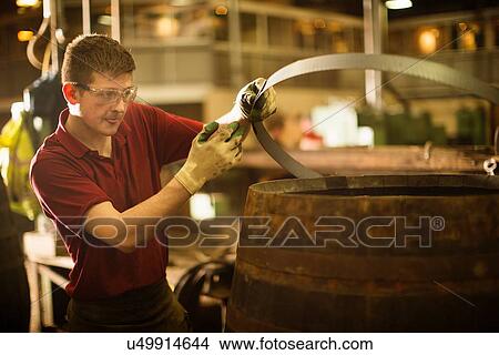 Picture - Young man working in cooperage. Fotosearch