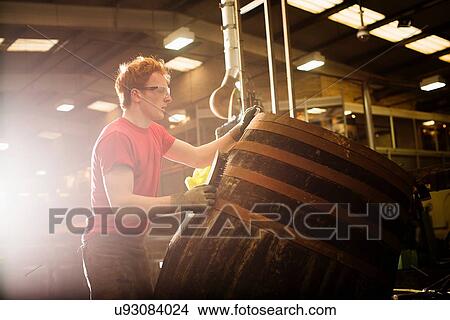 Young man working in cooperage View Large Photo Image Picture - Young man working in cooperage. Fotosearch