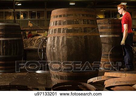 Young man working in cooperage View Large Photo Image Stock Image - Young man working in cooperage. Fotosearch
