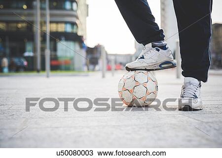 Young mans foot on soccer ball on city street View Large Photo Image Stock Image - Young mans foot on soccer ball on city street. Fotosearch