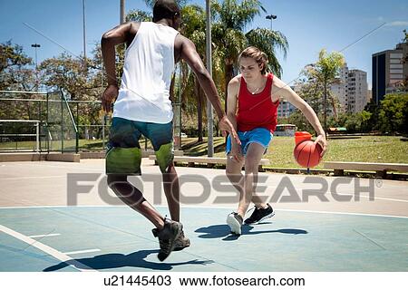 Young men practicing basketball on basketball court View Large Photo Image Stock Image - Young men practicing basketball on basketball court. Fotosearch