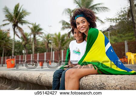 "Young mother and son wrapped in Brazilian flag on Ipanema beach, Rio De Janeiro, Brazil" View Large Photo Image Stock Photo - "Young mother and son wrapped in Brazilian flag on Ipanema beach, Rio De Janeiro, Brazil". Fotosearch
