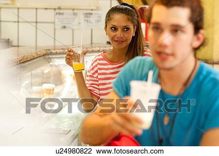 Stock Image - "Young tourist couple in juice bar, Copacabana town, Rio De Janeiro, Brazil". Fotosearch