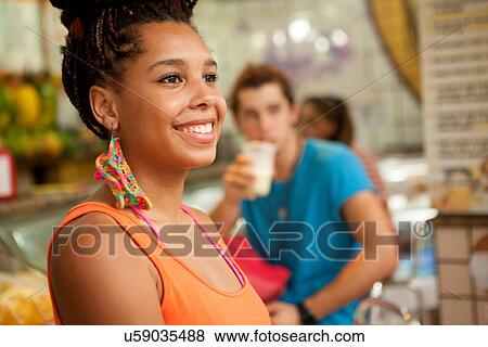 Stock Photo - "Young tourist friends drinking juice at juice bar, Copacabana town, Rio De Janeiro, Brazil". Fotosearch