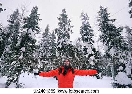 "Young woman celebrating in snow covered forest, Posio, Lapland, Finland" View Large Photo Image Stock Photo - "Young woman celebrating in snow covered forest, Posio, Lapland, Finland". Fotosearch