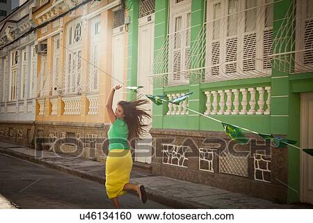 "Young woman celebrating with Brazilian flags in the street, Rio de Janeiro, Brazil" View Large Photo Image Stock Image - "Young woman celebrating with Brazilian flags in the street, Rio de Janeiro, Brazil". Fotosearch