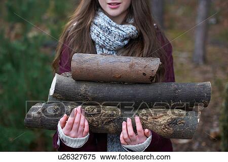 Young woman collecting logs for campfire in forest View Large Photo Image Stock Photography - Young woman collecting logs for campfire in forest. Fotosearch
