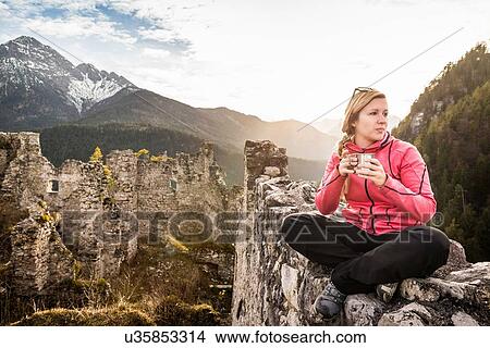 "Young woman drinking coffee on top of Ehrenberg castle ruins, Reutte, Tyrol, Austria" View Large Photo Image Picture - "Young woman drinking coffee on top of Ehrenberg castle ruins, Reutte, Tyrol, Austria". Fotosearch