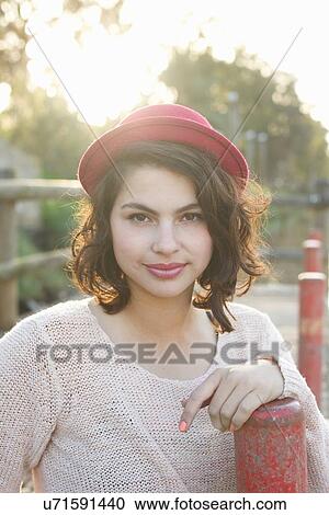 Stock Image - Young woman enjoying park. Fotosearch