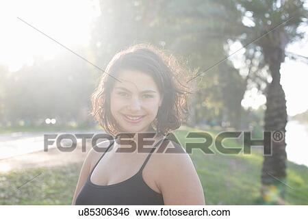 Stock Photograph - Young woman enjoying park. Fotosearch